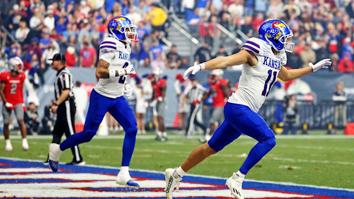 Dec 26, 2023; Phoenix, AZ, USA; Kansas Jayhawks wide receiver Luke Grimm (11) celebrates after scoring a touchdown in the Guaranteed Rate Bowl