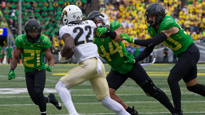 The Oregon defense stops Colorado's Alton McCaskill in the backfield during the fourth quarter in