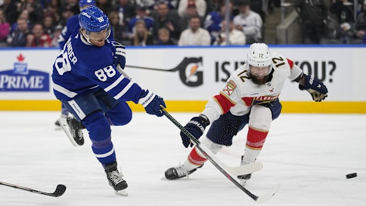 Apr 2, 2025; Toronto, Ontario, CAN; Toronto Maple Leafs forward William Nylander (88) shoots against Florida Panthers forward Jonah Gadjovich (12) during the third period at Scotiabank Arena. Mandatory Credit: John E. Sokolowski-Imagn Images