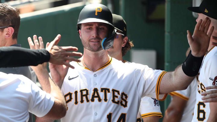 Jun 22, 2025; Pittsburgh, Pennsylvania, USA;  Pittsburgh Pirates catcher Joey Bart (14) high-fives in the dugout after scoring a run against the Texas Rangers during the fourth inning at PNC Park. Mandatory Credit: Charles LeClaire-Imagn Images