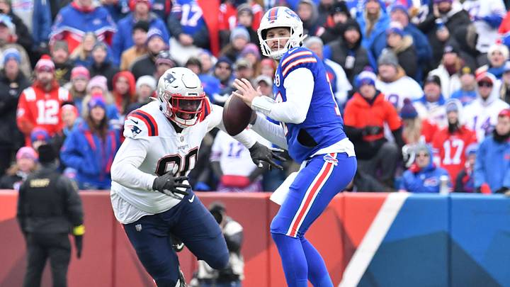 Jan 8, 2023; Orchard Park, New York, USA; Buffalo Bills' quarterback Josh Allen (17) prepares to throw a pass as New England Patriots' defensive tackle Christian Barmore (90) closes in during the second quarter at Highmark Stadium.