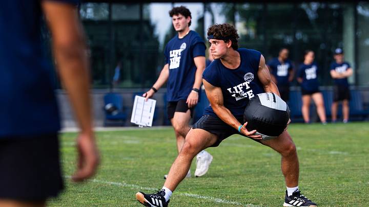 Penn State Nittany Lions quarterback Rocco Becht tosses a medicine ball during a relay race at the 23rd annual Lift for Life at Holuba Hall. 