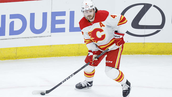 Jan 13, 2025; Chicago, Illinois, USA; Calgary Flames defenseman Rasmus Andersson (4) looks to pass the puck against the Chicago Blackhawks during the second period at United Center. Mandatory Credit: Kamil Krzaczynski-Imagn Images