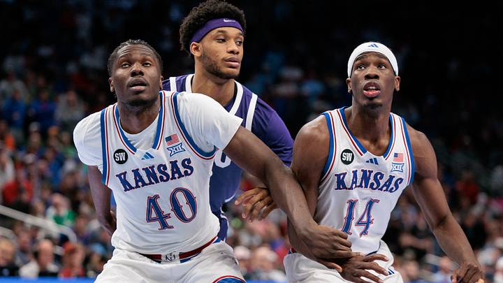 Mar 12, 2026; Kansas City, MO, USA; Kansas Jayhawks forward Flory Bidunga (40) and guard Melvin Council Jr. (14) block out during the second half against the TCU Horned Frogs at T-Mobile Center. Mandatory Credit: William Purnell-Imagn Images