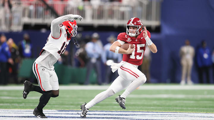 Dec 6, 2025; Atlanta, GA, USA; Alabama Crimson Tide quarterback Ty Simpson (15) rushes as Georgia Bulldogs linebacker Zayden Walker (10) defends during the fourth quarter during the 2025 SEC Championship game at Mercedes-Benz Stadium. Mandatory Credit: Brett Davis-Imagn Images