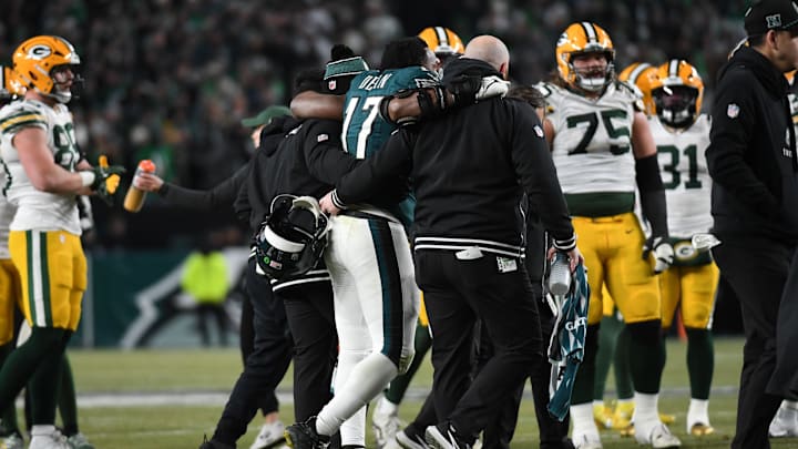 Jan 12, 2025; Philadelphia, Pennsylvania, USA; Philadelphia Eagles linebacker Nakobe Dean (17) is helped off the field against the Green Bay Packers during the first half in an NFC wild card game at Lincoln Financial Field. Mandatory Credit: Eric Hartline-Imagn Images