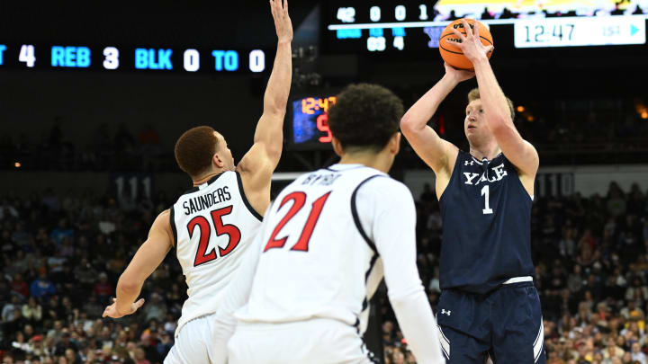 Mar 24, 2024; Spokane, WA, USA; Yale Bulldogs forward Danny Wolf (1) shoots the ball over San Diego State Aztecs forward Elijah Saunders (25) in the first half at Spokane Veterans Memorial Arena. Mandatory Credit: James Snook-USA TODAY Sports