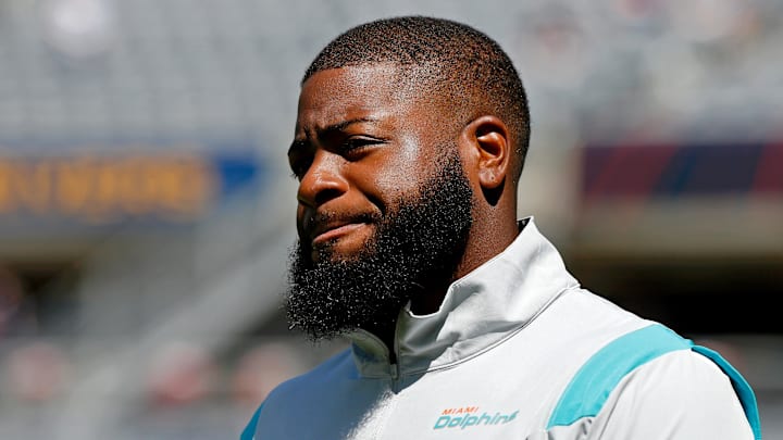 Miami Dolphins defensive backs coach Gerald Alexander walks on the field before the game against the Chicago Bears at Soldier Field. 