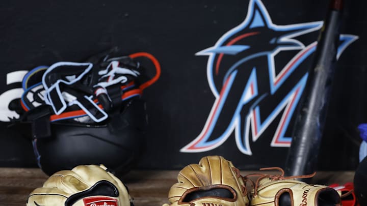 May 2, 2023; Miami, Florida, USA;  Gloves sit lined up in the Miami Marlins dugout against the Atlanta Braves before the game at loanDepot Park. Mandatory Credit: Rhona Wise-Imagn Images
