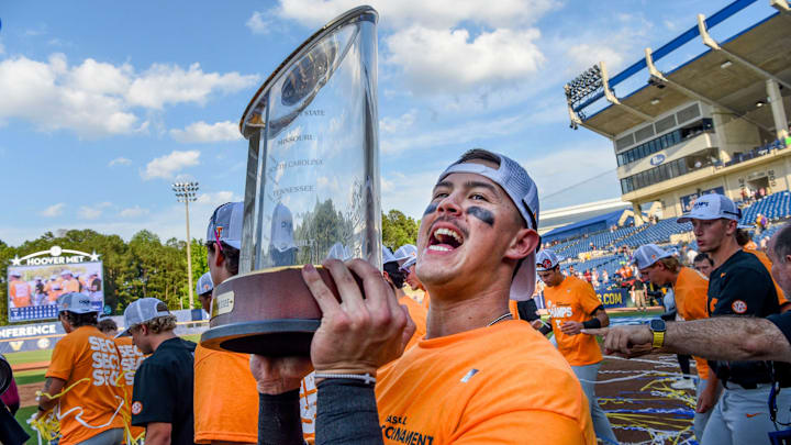 May 26 2024; Hoover, AL, USA; Tennessee outfielder Hunter Ensley (9) lifts the trophy in celebration at the Hoover Met following the championship game of the SEC Tournament. Tennessee held on to win 4-3.