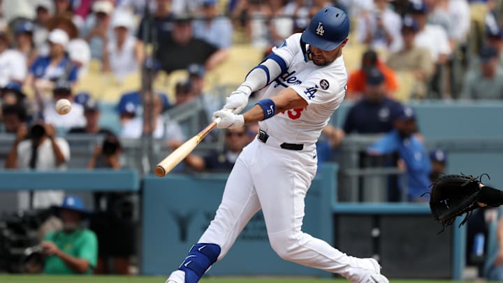 Sep 21, 2025; Los Angeles, California, USA; Los Angeles Dodgers left fielder Michael Conforto (23) hits an RBI single during the seventh inning against the San Francisco Giants at Dodger Stadium. Mandatory Credit: Kiyoshi Mio-Imagn Images