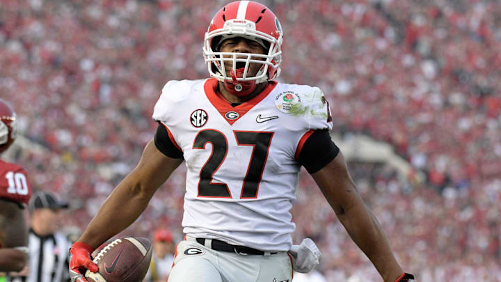 Jan 1, 2018; Pasadena, CA, USA; Georgia Bulldogs running back Nick Chubb (27) celebrates after scoring on a 50-yard touchdown run in the third quarter against the Oklahoma Sooners in the 2018 Rose Bowl college football playoff semifinal game at Rose Bowl Stadium. Georgia defeated Oklahoma 54-48 in two overtimes. Mandatory Credit: Kirby Lee-Imagn Images