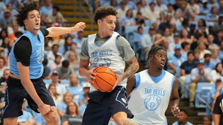 Oct 4, 2025; Charlotte, NC, USA; North Carolina Tar Heels guard Kyan Evans (0) grabs a rebound as forward Zayden High (1) defends in the second half at Dean E. Smith Center. Mandatory Credit: Bob Donnan-Imagn Images