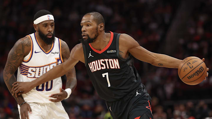 Jan 5, 2026; Houston, Texas, USA; Houston Rockets forward Kevin Durant (7) dribbles against Phoenix Suns forward Royce O'Neale (00) in the first quarter at Toyota Center. Mandatory Credit: Thomas Shea-Imagn Images