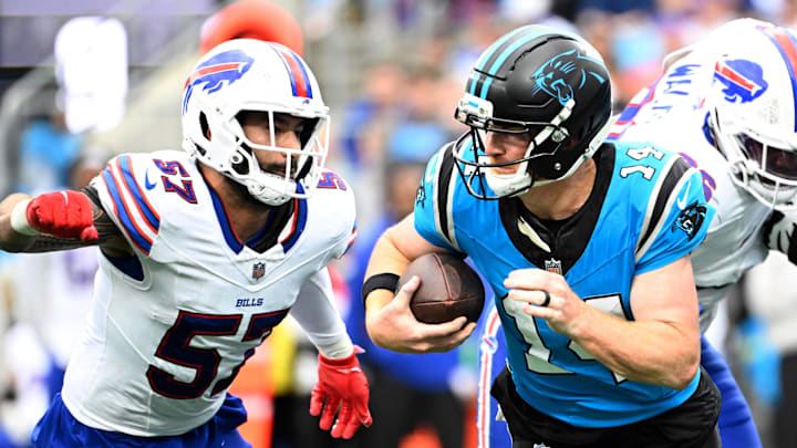 Oct 26, 2025; Charlotte, North Carolina, USA;  Carolina Panthers quarterback Andy Dalton (14) is sacked by Buffalo Bills defensive end AJ Epenesa (57) in the fourth quarter at Bank of America Stadium. Mandatory Credit: Bob Donnan-Imagn Images