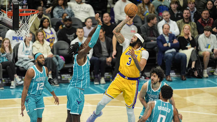 Jan 27, 2025; Charlotte, North Carolina, USA; Los Angeles Lakers forward Anthony Davis (3) shoots a jumper over Charlotte Hornets center Mark Williams (5) during the second quarter at the Spectrum Center. Mandatory Credit: Jim Dedmon-Imagn Images