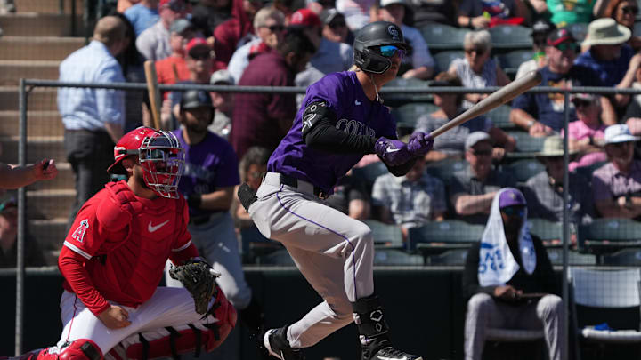 Tempe, Arizona, USA; Colorado Rockies outfielder Zac Veen (13) hits a single against the Los Angeles Angels in the second inning at Tempe Diablo Stadium.
