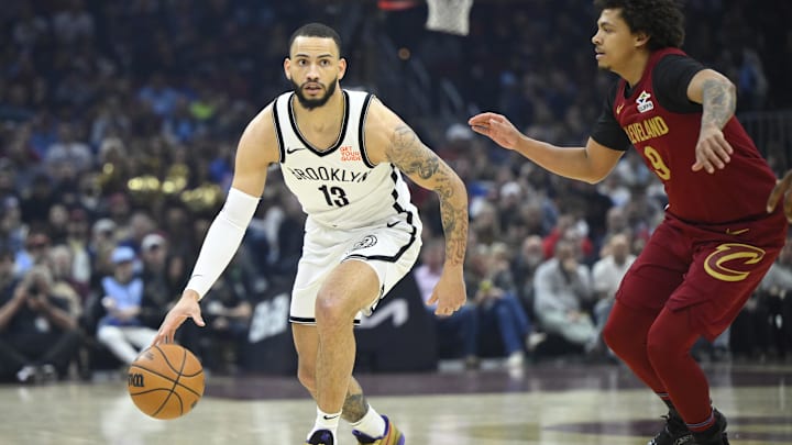 Mar 11, 2025; Cleveland, Ohio, USA; Brooklyn Nets guard Tyrese Martin (13) dribbles beside Cleveland Cavaliers guard Craig Porter Jr. (9) in the first quarter at Rocket Arena. Mandatory Credit: David Richard-Imagn Images