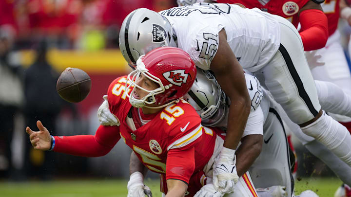 Dec 25, 2023; Kansas City, Missouri, USA; Kansas City Chiefs quarterback Patrick Mahomes (15) recovers his fumble as he is hit by Las Vegas Raiders defensive tackle Adam Butler (69) and defensive end Malcolm Koonce (51) during the first half at GEHA Field at Arrowhead Stadium. Mandatory Credit: Jay Biggerstaff-Imagn Images Dec 25, 2023; Kansas City, Missouri, USA; Kansas City Chiefs quarterback Patrick Mahomes (15) recovers his fumble as he is hit by Las Vegas Raiders defensive tackle Adam Butler (69) and defensive end Malcolm Koonce (51) during the first half at GEHA Field at Arrowhead Stadium. Mandatory Credit: Jay Biggerstaff-Imagn Images