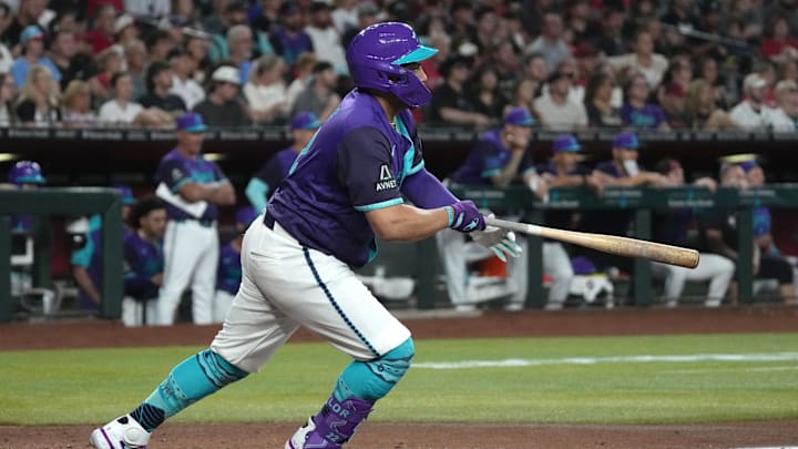 Jul 5, 2025; Phoenix, Arizona, USA; Arizona Diamondbacks first baseman Josh Naylor (22) hits an RBI single against the Kansas City Royals in the third inning at Chase Field. Mandatory Credit: Rick Scuteri-Imagn Images