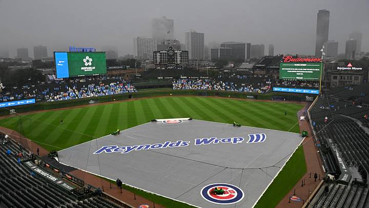 Jul 4, 2026; Chicago, Illinois, USA;  The tarp sits on the field as rain delayed the game between the Chicago Cubs and the St. Louis Cardinals at Wrigley Field. Mandatory Credit: Matt Marton-Imagn Images