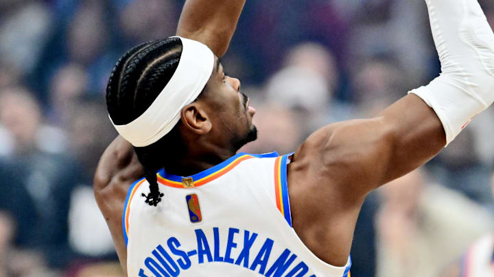 Jan 19, 2026; Cleveland, Ohio, USA; Oklahoma City Thunder guard Shai Gilgeous-Alexander (2) shoots over the defense of Cleveland Cavaliers guard Donovan Mitchell (45) during the first quarter at Rocket Arena. Mandatory Credit: Ken Blaze-Imagn Images
