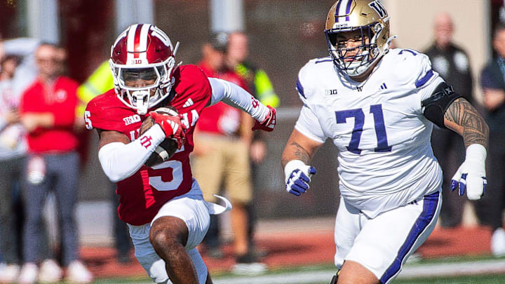 Indiana's D'Angelo Ponds (5) returns an interception 67 yards for a touchdown as the UW's Kahlee Tafai gives chase. 