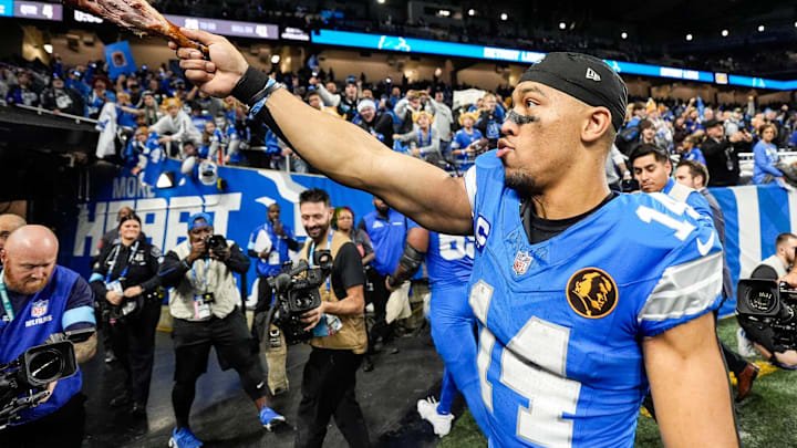 Detroit Lions wide receiver Amon-Ra St. Brown (14) waves a turkey leg at fans to celebrate 23-20 win over Chicago Bears at Ford Field in Detroit on Thursday, Nov. 28, 2024.