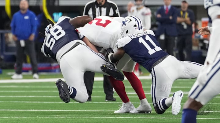 New York Giants quarterback Drew Lock is sacked by Dallas Cowboys defensive tackle Mazi Smith and linebacker Micah Parsons.