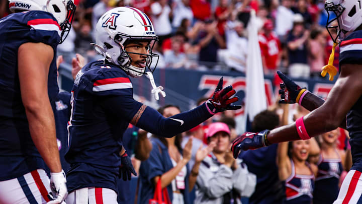 Oct 11, 2025; Tucson, Arizona, USA; Arizona Wildcats wide receiver Kris Hutson (4) celebrates a touchdown he made during the first quarter of the game against the Brigham Young Cougars at Arizona Stadium. Mandatory Credit: Aryanna Frank-Imagn Images Oct 11, 2025; Tucson, Arizona, USA; Arizona Wildcats wide receiver Kris Hutson (4) celebrates a touchdown he made during the first quarter of the game against the Brigham Young Cougars at Arizona Stadium. Mandatory Credit: Aryanna Frank-Imagn Images