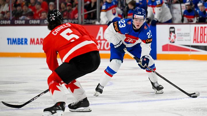 Jan 2, 2026; Minneapolis, Minnesota, USA; Slovakia forward Jakub Dubravik (23) controls the puck as Canada defensemen Carson Carels (5) defends during the first period in the quarterfinals of the 2026 IIHF World Junior Championship at 3M Arena. Mandatory Credit: Nick Wosika-Imagn Images Jan 2, 2026; Minneapolis, Minnesota, USA; Slovakia forward Jakub Dubravik (23) controls the puck as Canada defensemen Carson Carels (5) defends during the first period in the quarterfinals of the 2026 IIHF World Junior Championship at 3M Arena. Mandatory Credit: Nick Wosika-Imagn Images