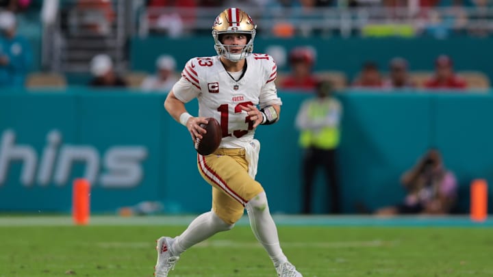 Dec 22, 2024; Miami Gardens, Florida, USA; San Francisco 49ers quarterback Brock Purdy (13) runs with the football against the Miami Dolphins during the second quarter at Hard Rock Stadium. Mandatory Credit: Sam Navarro-Imagn Images