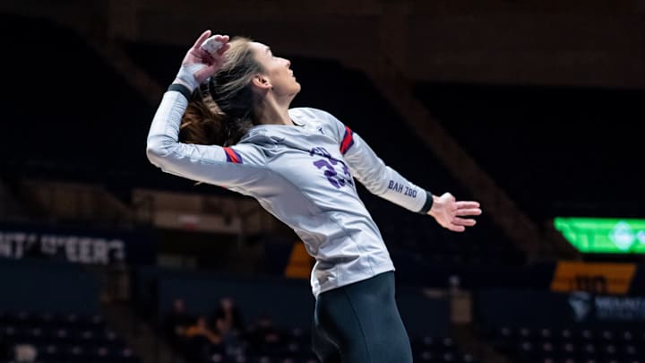 Nov. 28, 2024- TCU Volleyball's Melanie Parra (23) leaps up to land a kill against Cincinnati.