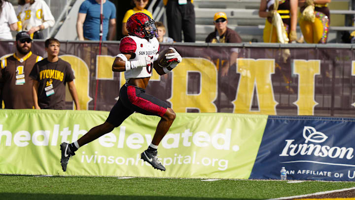 Oct 12, 2024; Laramie, Wyoming, USA; San Diego State Aztecs safety Eric Butler (6) intercepts a pass and scores a touchdown against the Wyoming Cowboys during the first quarter at Jonah Field at War Memorial Stadium. Mandatory Credit: Troy Babbitt-Imagn Images