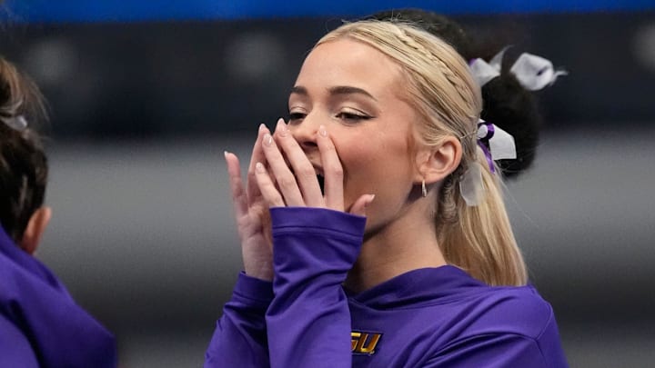 LSU gymnast Livvy Dunne stretches with teammates before Session 2 of the SEC Gymnastics Tournament.