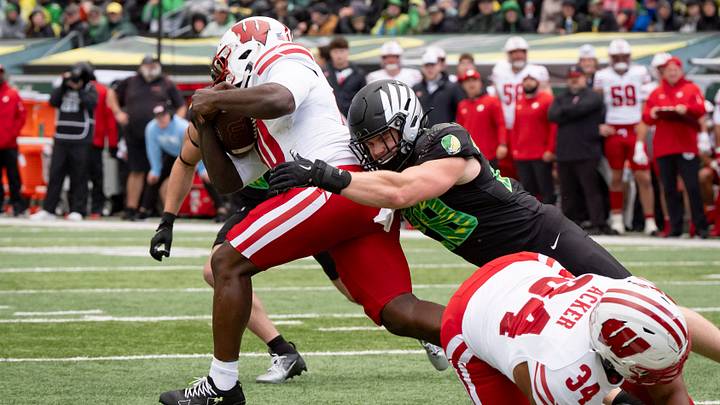 Oregon inside linebacker Bryce Boettcher wrangles Wisconsin running back Gideon Ituka as the Oregon Ducks host the Wisconsin Badgers on Oct. 25, 2025, at Autzen Stadium in Eugene, Oregon.
