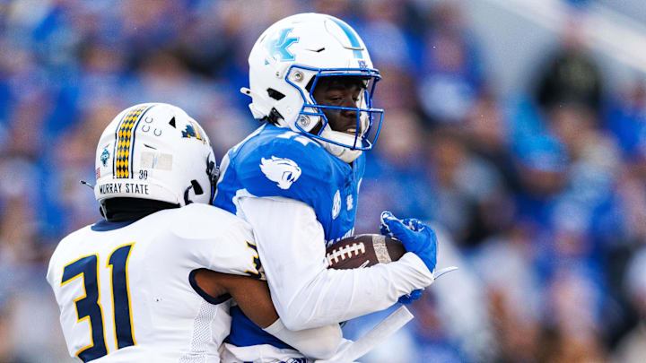 Nov 16, 2024; Lexington, Kentucky, USA; Murray State Racers defensive back James Jackson tackles Kentucky Wildcats wide receiver Hardley Gilmore IV (17) during the second quarter at Kroger Field. Mandatory Credit: Jordan Prather-Imagn Images