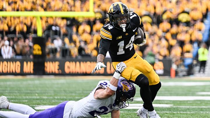 Sep 19, 2026; Iowa City, Iowa, USA;  Iowa Hawkeyes wide receiver Tony Diaz (14) tries to escape from UNI Panthers safety Calvin Jaworski (21) during the second quarter at Kinnick Stadium.  Mandatory Credit: Jeffrey Becker-Imagn Images