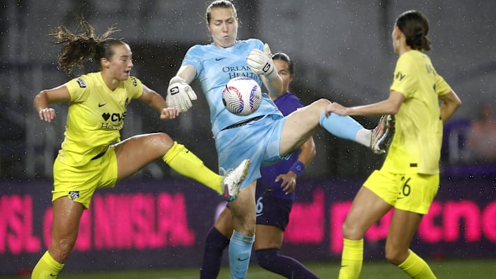 Oct 6, 2024; Orlando, Florida, USA; Washington Spirit defender Tara McKeown (9) and midfielder Paige Metayer (26) battle Orlando Pride goalkeeper Anna Moorhouse (1) for the ball in front of the goal in the second half at Inter&Co Stadium. Mandatory Credit: Russell Lansford-Imagn Images