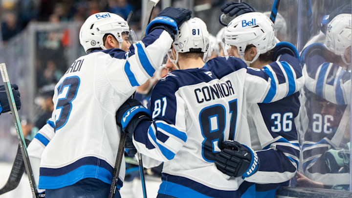 Mar 16, 2025; Seattle, Washington, USA;  Winnipeg Jets forward Kyle Connor (81) celebrates after scoring a goal with forward Gabriel Vilardi (13) and forward Morgan Barron (36) during the second period against the Seattle Kraken at Climate Pledge Arena. Mandatory Credit: Stephen Brashear-Imagn Images