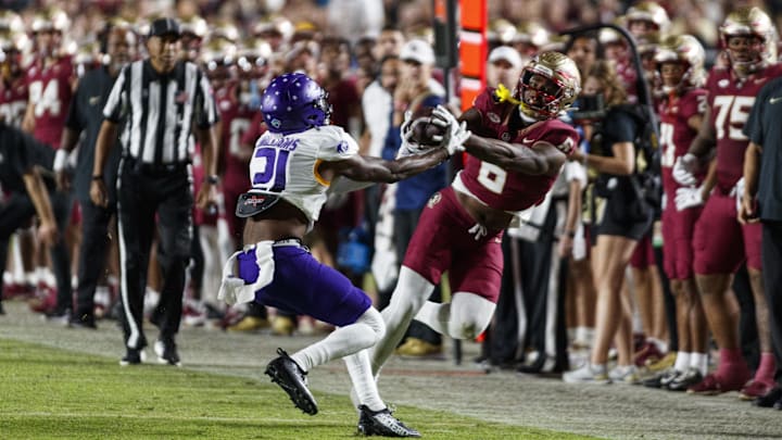 Nov 18, 2023; Tallahassee, Florida, USA; Florida State Seminoles tight end Jaheim Bell (6) catches the ball under pressure from North Alabama Lions linebacker Ashaad Williams (21) during the third quarter at Doak S. Campbell Stadium. Mandatory Credit: Morgan Tencza-Imagn Images Nov 18, 2023; Tallahassee, Florida, USA; Florida State Seminoles tight end Jaheim Bell (6) catches the ball under pressure from North Alabama Lions linebacker Ashaad Williams (21) during the third quarter at Doak S. Campbell Stadium. Mandatory Credit: Morgan Tencza-Imagn Images
