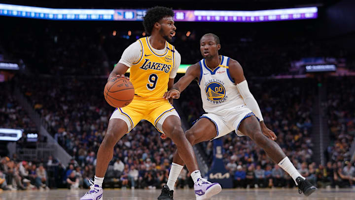 Los Angeles Lakers guard Bronny James (9) dribbles the ball next to Golden State Warriors forward Jonathan Kuminga (00) in the second quarter at the Chase Center. Mandatory Credit: