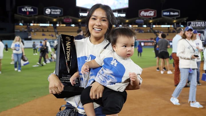 Kristen Edman, wife of Los Angeles Dodgers shortstop Tommy Edman, celebrates with his MVP trophy after the win against the New York Mets in Game 6 of the NLCS.