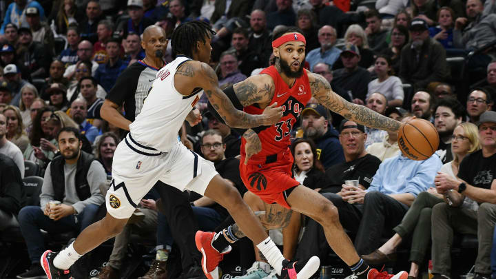 Mar 12, 2022; Denver, Colorado, USA; Toronto Raptors guard Gary Trent Jr. (33) drives on Denver Nuggets guard Bones Hyland (3) during the third quarter at Ball Arena. Mandatory Credit: John Leyba-USA TODAY Sports