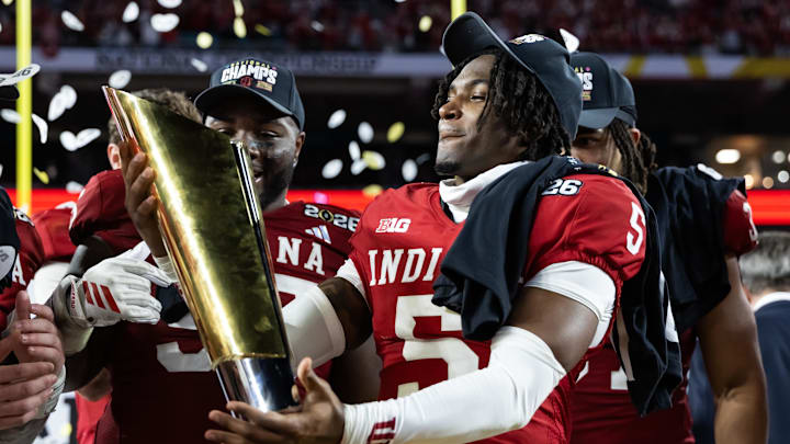 Jan 19, 2026; Miami Gardens, FL, USA; Indiana Hoosiers defensive back D'Angelo Ponds (5) celebrates with the trophy after defeating the Miami Hurricanes in the College Football Playoff National Championship game at Hard Rock Stadium. Mandatory Credit: Mark J. Rebilas-Imagn Images