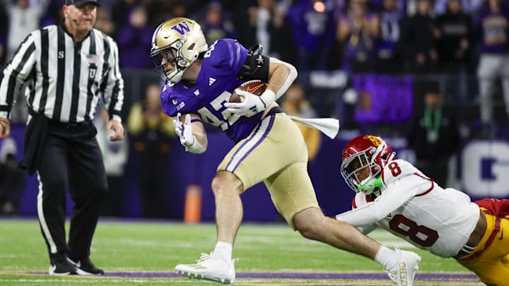 Nov 2, 2024; Seattle, Washington, USA; Washington Huskies linebacker Carson Bruener (42) returns an interception against USC Trojans wide receiver JaKobi Lane (8) during the third quarter at Alaska Airlines Field at Husky Stadium. Mandatory Credit: Joe Nicholson-Imagn Images