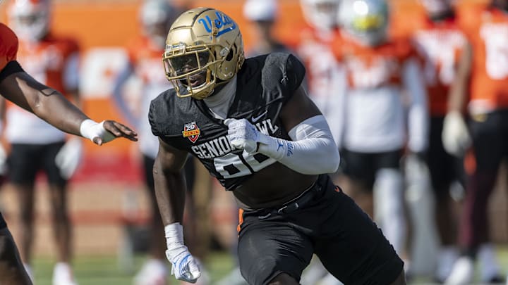 Jan 29, 2025; Mobile, AL, USA; National team defensive lineman Oluwafemi Oladejo of UCLA (99) runs through a drill during Senior Bowl practice at Hancock Whitney Stadium. Mandatory Credit: Vasha Hunt-Imagn Images