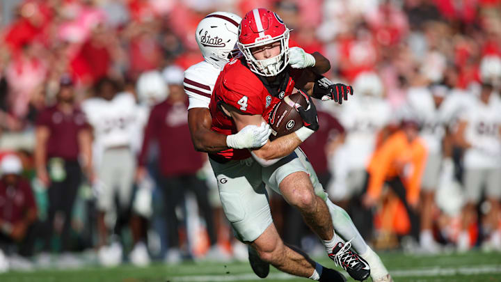 Oct 12, 2024; Athens, Georgia, USA; Georgia Bulldogs tight end Oscar Delp (4) is tackled by Mississippi State Bulldogs safety Isaac Smith (2) in the second quarter at Sanford Stadium. Mandatory Credit: Brett Davis-Imagn Images
