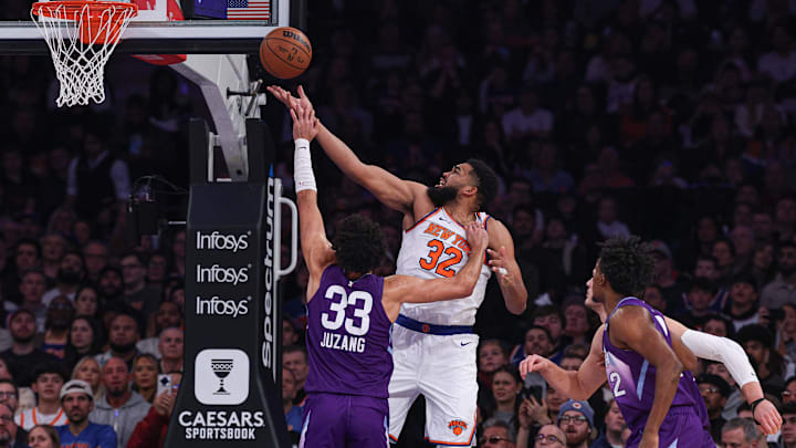 Jan 1, 2025; New York, New York, USA; New York Knicks center Karl-Anthony Towns (32) goes to the basket against Utah Jazz guard Johnny Juzang (33) during the first half at Madison Square Garden. Mandatory Credit: Vincent Carchietta-Imagn Images
