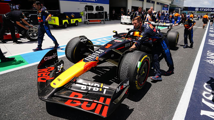 May 4, 2024; Miami Gardens, Florida, USA; Crew members push the car of Red Bull Racing driver Max Verstappen (1) back to the paddock  after the F1 Sprint Race at Miami International Autodrome. Mandatory Credit: John David Mercer-Imagn Images